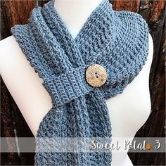 a blue scarf with a button on it