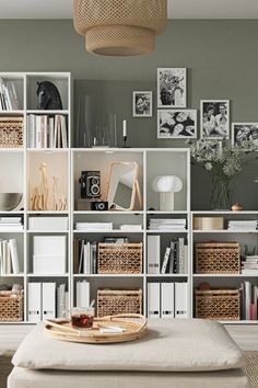 a living room filled with lots of furniture and bookshelves on top of each other