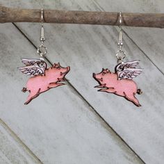 "\"When Pigs fly\" they do with these Realistic Flying Pig Dangle Earrings. This bovine jewelry is lightweight, hand-painted, hypoallergenic, and nickel free. Extremely lightweight Hypoallergenic, nickel-free All earrings are made from surgical steel Carefully cut from Birch for both beauty and strength Hand-painted Lifetime replacement for the cost of shipping Custom designs available, our motto is \"if you dream it, we will make it an earring.\"" Flying Pig Earrings, Pig Jewelry, Pig Earrings, Peace Earrings, Cute Piglets, Pigs Fly, Pig Lovers, Cute Giraffe, Flying Pig