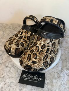 MyStyleMyWay's  custom crocs are designed for the perfect outfit, that special occasion, and "Just Because" you love blinged out crocs.  In the display shown we designed a pair of black "Cheetah Print Design" classic crocs adding high quality colorful rhinestones. 🐆Each Rhinestone is individually and neatly placed to achieve the design.  🐆Rhinestones are added to the top and buttom trimming of the shoe.  🐆This design was personalized. 🐆The sports mode strap is also designed.   🐆This design do not have charms or patches. charms can be added please contact us directly to discuss charm options.  🐆When making your purchase - You're making a purchase for the exact style shown. If you would like a different color rhinestone,  and or different charms please message us so we can assist you. Cheetah Crocs, Blinged Out Crocs, Bedazzled Crocs, Crocs Aesthetic, Bling Crocs, Cheetah Print Design, Womens Clogs And Mules, Custom Crocs, Classic Crocs