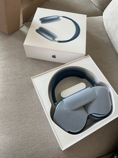 an apple watch in a box sitting on the floor next to it's packaging