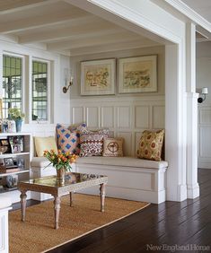 a living room filled with furniture and decor on top of a hard wood floored floor