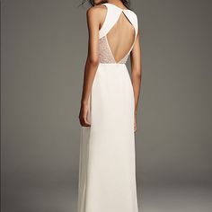 a woman in a long white dress with an open back and beaded neckline