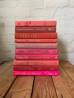 a stack of books sitting on top of a wooden table