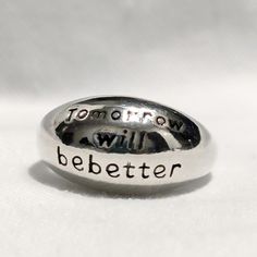 Discover hope and positivity with our "Tomorrow Will Be Better" Ring, beautifully crafted from high-quality sterling silver. This adjustable statement ring serves as a daily reminder that brighter days are ahead, making it the perfect piece for anyone seeking encouragement and motivation. Its sleek design and elegant finish make it versatile enough for everyday wear or as a meaningful gift for a loved one. The adjustable band ensures a comfortable fit on any finger, so you can carry its inspiring message wherever you go. Embrace the power of positive thinking with this timeless, motivational sterling silver ring. Inspirational Hand Stamped Silver Rings, Inspirational Silver Promise Ring, Meaningful Sterling Silver Promise Ring Engraved, Meaningful Sterling Silver Engraved Ring, Meaningful Engraved Sterling Silver Promise Ring, Meaningful Sterling Silver Promise Ring, Meaningful Hypoallergenic Silver Rings, Inspirational Silver Rings For Anniversary, Inspirational Sterling Silver Jewelry With Engraved Text