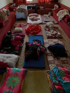 a room filled with lots of different types of blankets and pillows on top of each other