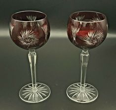 two wine glasses sitting next to each other on a table