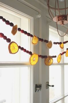 some fruit is hanging on the side of a window sill in front of a light fixture