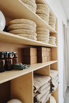 the shelves are filled with baskets and towels