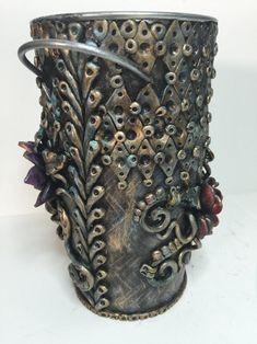 a metal vase with intricate designs on it