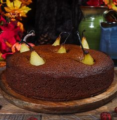 there is a chocolate cake with pears on the top and two slices cut out