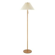 a floor lamp with a white shade on the top and a wooden base in front of it