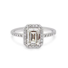 an emerald cut diamond ring with diamonds around it