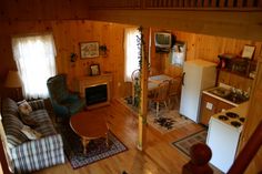 an aerial view of a living room, kitchen and dining area in a log cabin