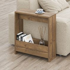 a wooden table with some books on it and a cup sitting on top of it