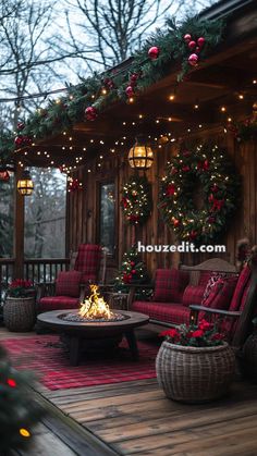 an outdoor deck decorated for christmas with red and green decorations on the porch, lights strung over the fire pit