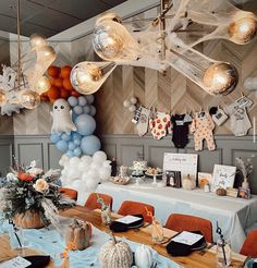 a party with balloons and decorations hanging from the ceiling