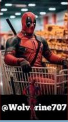 a man in a deadpool costume is pushing a shopping cart through a store aisle