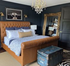 A classic bedroom with dark walls, a gold chandelier, an English leather tufted queen-sized bed and a three-panel black door. Luxurious Bathtubs, Dark Doors, Hollow Core Doors, Solid Core, Classic Bedroom, Unique Beds, Home Center