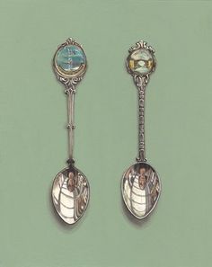 two spoons with pictures on them are next to each other in front of a green background