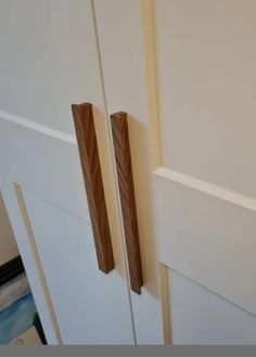 the door handles are made from wood and have long strips of tape attached to them