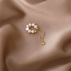 Finish your look with this dreamy ear cuff offering a row of shimmering pearls and a star charm accent that hangs from a delicate 18k gold-plated chain. Includes one ear cuff 0.63" W x 1.73" L 18k gold-plated copper / pearl Fairy Earrings, Tassel Earing, Copper Pearl, Kawaii Jewelry, Cat Bow, Star Chain, Charm Chain, Bow Earrings, Lipstick Makeup