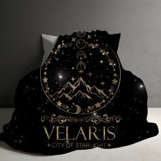 a black and gold cover with the words velaris city of starlight on it