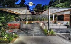 an outdoor patio with seating and lights at night