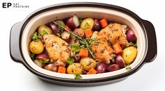 chicken, potatoes and carrots in a crock pot on a white table top