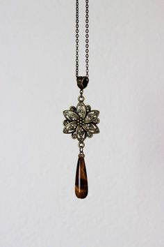 This long eautiful brass boho necklace was made of brown cat's eye stone drop bead, antique brass flower charm, brass bail, antique brass chain with antique brass tone lobster clasp. The chain is from lead free & nickel free metall. A wonderful jewelry for everyday wear and a great gift! Length of chain is about 68 cm or about 26,8 inches Other necklaces of my shop you can see here: https://www.etsy.com/shop/NaTavelli?section_id=14843046&ref=shopsection_leftnav_5 Thanks for a visit. Purple Stone Necklace, Long Stone Necklace, Anchor Jewelry, Brown Gemstone, Stainless Steel Chain Necklace, Necklace Purple, Single Bead, Brass Necklace, Amethyst Beads