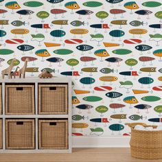 colorful fish wallpaper in a child's room with storage baskets and toy chest