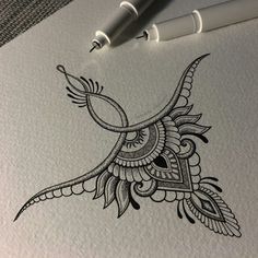 an ink drawing of a bird on paper next to two markers and a ballpoint pen