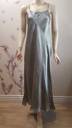 This is 100% pure satin strap slip dress. The perfect minimalist gown for the woman who adores luxury and simplicity. There is something so special about a bias cut silk gown and natural silk epitomizes that effortless glamour.  Our Silk gown is so buttery soft that you'll never want to take it off. This dress does triple duty as a night gown, slip dress or just a slip! This will be your favorite piece to pack away to that island paradise or to wear at home.  Add a sweater, jacket, or wear it on its own and you have the perfect outfit for dinner and dancing! A silky feel that adds femme sophistication to any look, this camisole/lingerie dress is a delicate piece you'll find yourself reaching for again and again. Subtle shine lends a classic charm to its versatile silhouette. Made from smoo Minimalist Gown, Silk Satin Dress, Island Paradise, Silk Gown, Lingerie Dress, Dinner Outfits, Natural Silk, Luxury Clothing, Satin Dress