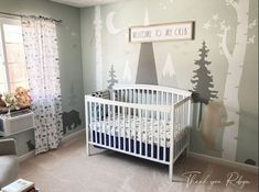 a baby's room decorated in gray and white