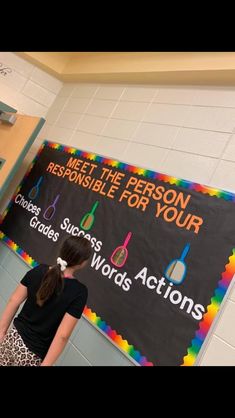 a girl standing in front of a sign that says meet the person responsible for your choice