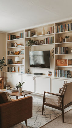 a living room filled with furniture and a flat screen tv on top of a book shelf