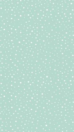 an image of snow falling on the ground in the day light blue sky with little white dots