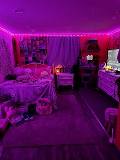 a bedroom with purple lighting and lots of stuff on the floor