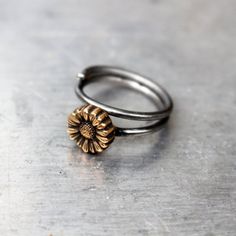 Adjustable floral sunflower ring to wear as knuckle ring, toe ring or as a regular ring on any finger. The tiny flower is made in bronze and the adjustable ring band in stainless steel. Both bronze and steel are strong hard metals and this makes a very durable design. MADE ON DEMAND, takes me up to 7 workdays to complete.Here you find other designs with flowers https://www.etsy.com/se-en/shop/AnnaSiivonen?ref=seller-platform-mcnav&search_query=flower Adjustable Gold Metal Flower Ring, Adjustable Gold Flower Ring In Brass, Adjustable Gold Brass Flower Ring, Adjustable Flower Shaped Metal Ring, Adjustable Metal Flower Ring, Adjustable Sunflower Design Flower Ring, Adjustable Sunflower Design Flower Ring Gift, Dainty Adjustable Hand Forged Stackable Rings, Dainty Adjustable Stackable Metal Rings