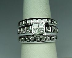 a white gold ring set with princess cut diamonds