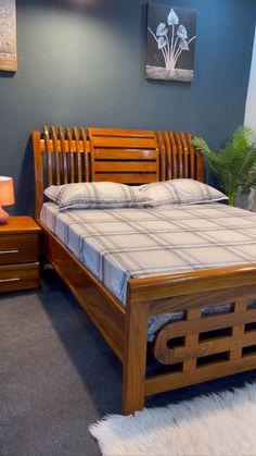 a bed with wooden headboard and foot board sitting in a room filled with furniture