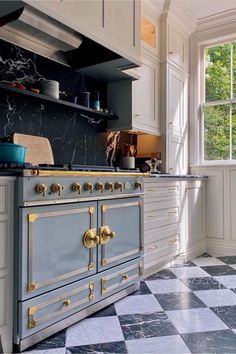 a kitchen with marble counter tops and an old fashioned stove top oven in the center