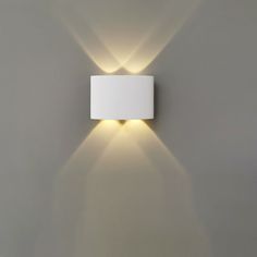 a square light fixture mounted on the wall