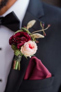 a man in a tuxedo with a boutonniere on his lapel