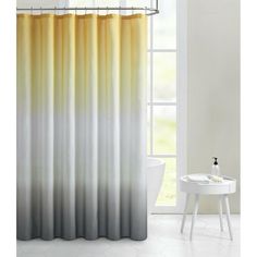 a shower curtain with yellow and grey ombrees on the outside, in front of a window