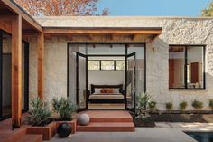 an outdoor living area with steps leading up to the bedroom and sitting area on the other side