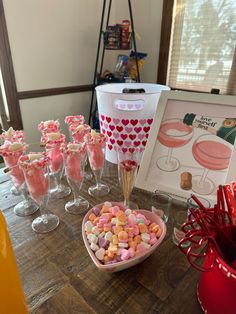 a table topped with wine glasses filled with candy