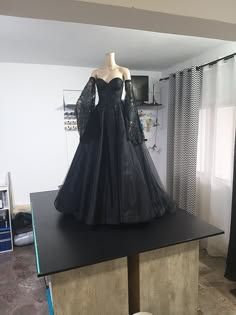 a black dress is on display in a room