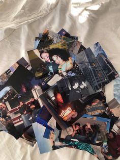 a pile of photos sitting on top of a white sheet