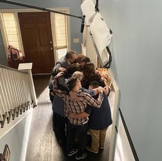 a group of people hugging each other on the stairs